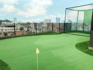 a golf court with a net on a green field at The Bloom Pham Viet Chanh in Ho Chi Minh City