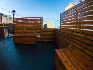 
a row of wooden benches sitting next to each other at Casa Urbana Hotel in Córdoba
