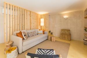 a living room with a white couch in a room at Sea'Ya Thoughtful Stays - Villas in Cascais