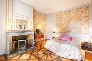 a bedroom with a bed and a fireplace at CHATEAU MONTALEMBERT Maîche in Maîche