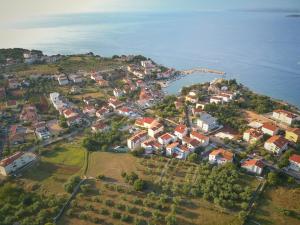an aerial view of a village on a hill by the water at Apartman I&A in Porat