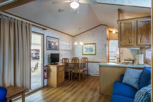 a kitchen and living room with a couch and a table at Bethpage One-Bedroom Cottage 1 in Urbanna