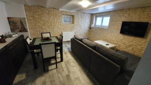 a living room with a couch and a table at "LE TRAMWAY" Appartement 150m gare des Aubrais in Fleury-les-Aubrais