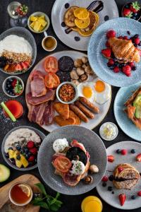 a table topped with plates of breakfast food on plates at Radisson Blu Hotel, Liverpool in Liverpool