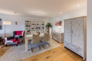 a living room with a table and a chair at Premium Business Apartment Oberkochen Zentrum in Oberkochen