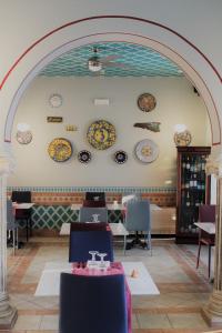 a dining room with plates on the wall at Hotel Medusa in Lampedusa