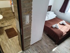 A bed or beds in a room at Duna Dráva Vendégház
