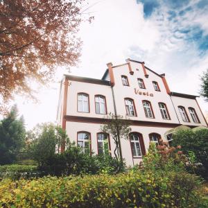 een groot wit gebouw met de woorden uva erop bij Hotel - Pension Vesta in Bad Elster