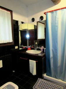 a bathroom with a sink and a toilet and a mirror at ARIOSTEA Ap.1 in Ferrara