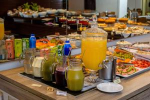 a buffet with drinks and food on a table at Bahamas Duplex by WS in Campo Grande