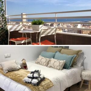 a bed on a balcony with a view of a city at Apartamento in Alicante +15 photos