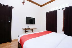 A bed or beds in a room at Kovalam Beach Hotel