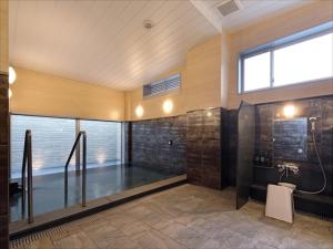 a bathroom with a shower and a sink at Kurayoshi City Hotel in Kurayoshi