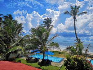 a view of the ocean from the balcony of a resort at Tropical Beach House Hikkaduwa in Hikkaduwa