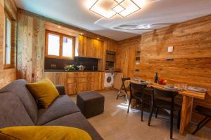 a living room with a couch and a table at Marlies Ski in - Ski out Mt 50 - Happy Rentals in Livigno