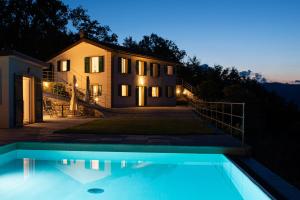 a villa with a swimming pool in front of a house at Il Leccio - Luxury Resort Portofino Monte in Santa Margherita Ligure