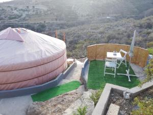 a large dome house with a table and a chair at Yurta de Arico in Arico Viejo