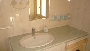 a bathroom with a sink and a mirror at Appartement Centre Ville Tours in Tours +18 photos