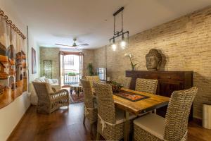 a dining room with a wooden table and chairs at LUXURIOUS & ALLURING HOME IN HISTORIC TOWN (VALENCIA) in Valencia