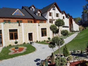 uma casa com um jardim na frente em Apartment S&A Milmari Resort S43 em Kopaonik