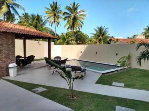 a patio with chairs and a swimming pool at MAKAIBA RESIDENCE - FLATS DA Jô 001 in Baraúna