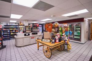a grocery store aisle with a cart in a store at Bethpage One-Bedroom Cottage 1 in Urbanna