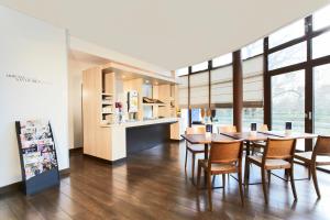 a kitchen and dining room with a table and chairs at Kyriad Viry-Chatillon in Viry-Châtillon
