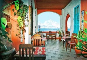a restaurant with tables and chairs and a view of the ocean at Bed & breakfast Villa Carmo in Salvador