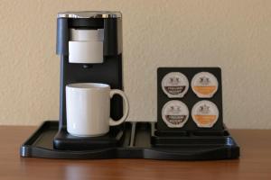 a coffee maker with a cup on a table at The Portlander Inn and Marketplace in Portland