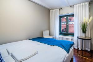 Łóżko lub łóżka w pokoju w obiekcie Apartamenty na Starówce / Old Town apartments