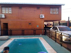 a swimming pool in front of a house at O NEGRAÕ in Puerto Iguazú