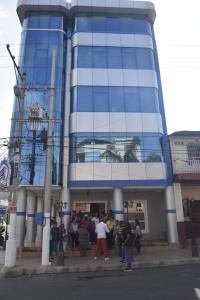 a group of people standing outside of a building at Olan´s Hotel Group in Esmeraldas