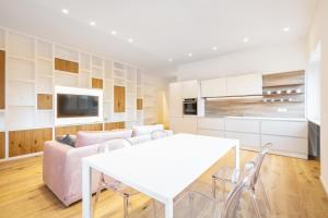 a kitchen and living room with a white table and chairs at NIMA Boutique House in Perugia