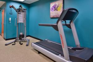 a gym with a treadmill and an exercise bike at Best Western Plus University Inn in Olean