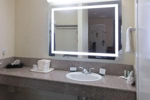 a bathroom with a sink and a large mirror at Quality Inn Salinas City Center Area in Salinas +17 photos