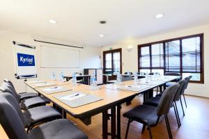 a large conference room with a large table and chairs at Kyriad Angers Sud Ponts-De-Cé in Les Ponts-de-Cé