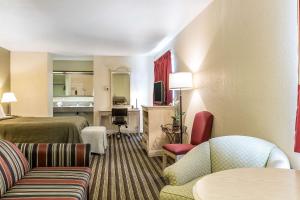 a hotel room with a bed and a living room at Quality Inn Salinas City Center Area in Salinas