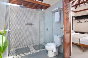 a bathroom with a shower with a toilet in it at Ke Rensia Private Pool Villas Gili Air in Gili Islands