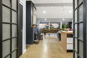 a hallway with a living room and a dining room at The Bird House in Mount Tamborine