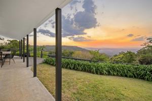 a view of the sunset from the deck of a house at The Bird House in Mount Tamborine