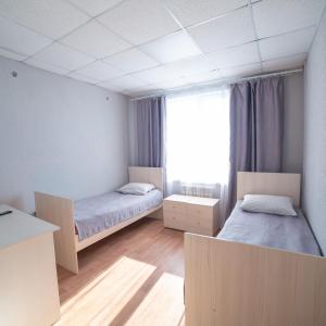a bed room with two beds and a desk at Mebis Baikal in Turkinski