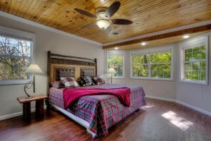 a bedroom with a bed and a ceiling fan at 5Bedrooms*4KING BEDS*OUTSTANDING LOCATION*HotTub* in Sevierville