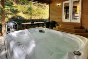 a large bath tub sitting outside of a house at 5Bedrooms*4KING BEDS*OUTSTANDING LOCATION*HotTub* in Sevierville +60 photos
