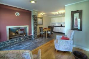 a living room with a fireplace and a table and chairs at Number 15 Ocean & City View Villas in Funchal