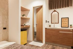 a bedroom with a sink and a mirror at Vann Bangkok Boutique House in Bangkok +123 photos