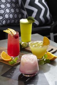 a group of three cocktails on a table at ARTOTEL Thamrin Jakarta in Jakarta