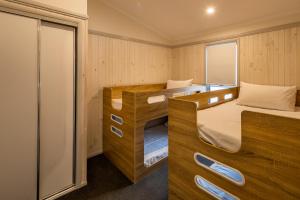 a small room with two bunk beds in it at Ingenia Holidays White Albatross in Nambucca Heads