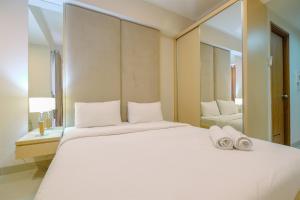 Ένα ή περισσότερα κρεβάτια σε δωμάτιο στο Exclusive Studio at The Oasis Cikarang Apartment By Travelio