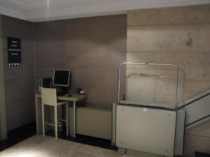 a small kitchen with a refrigerator and a television at Hotel Room in Pontevedra