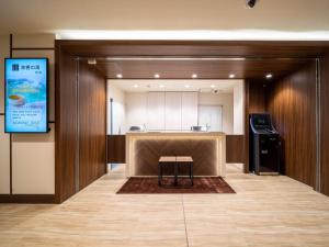 a room with a kitchen and a table in a building at Super Hotel Premier Shimonoseki in Shimonoseki